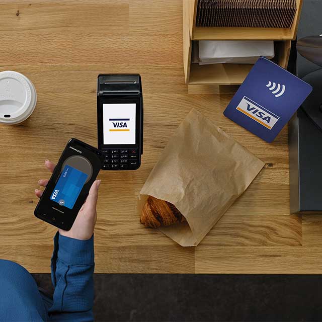Customer paying for a purchase via a mobile phone using Samsung Pay.