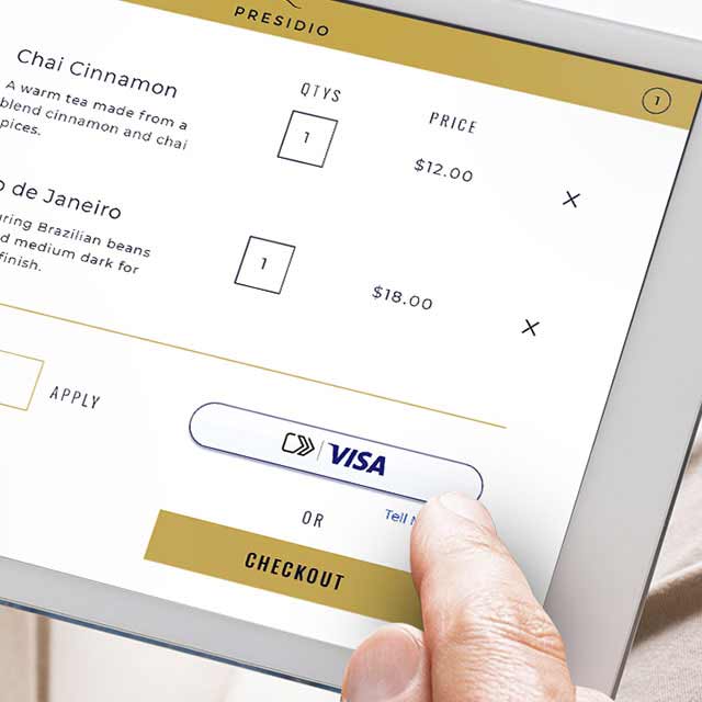 A person uses an iPad to make a secure online payment with Visa credit card, ensuring a safe and convenient checkout process. 